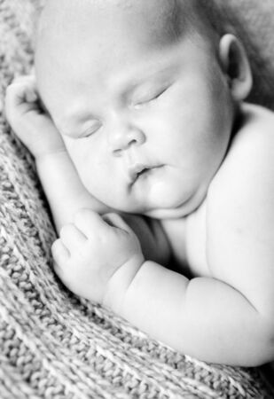 black-and-white. sleeping newborn baby. the care of children. peaceful sleep of a child.の写真素材