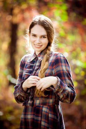 the woman in the plaid dress in the autumn forest. nature walks.