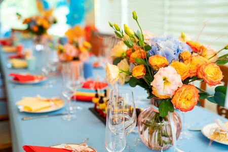 vase with flowers on a festive table. the decoration of a celebratory Banquet.の写真素材