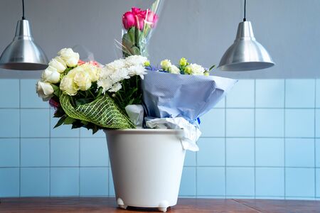 bouquets in a white bucket. storage of donated flowers during the Banquet at the restaurant.の写真素材