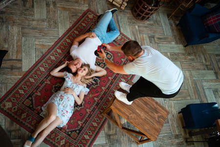 the lovers lie on a carpet in front of the fireplace and a photographer to make photos. honeymoon....