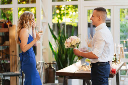 the guy an offer hands and hearts, gives engagement ring to his girlfriend. romantic surprise.
