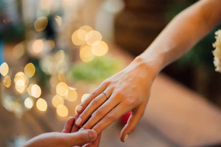 hand women with a wedding ring. offer hands and hearts.