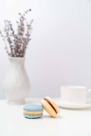 macarons on background tea Cup and a vase with lavender on a white table. table setting for tea.の写真素材