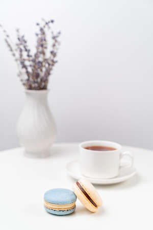 macarons on background tea Cup and a vase with lavender on a white table. table setting for tea.の写真素材