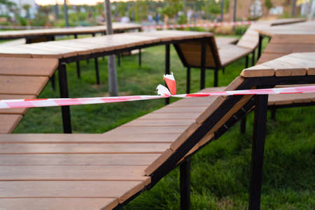 closed sports playground with wooden benches in a residential area, in a park, near the shopping...