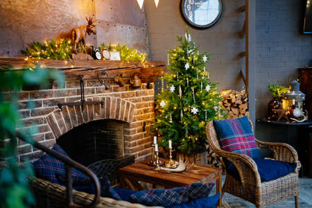 Christmas decor of the house with a fireplace. cozy holiday interior of a country house. new year.の写真素材