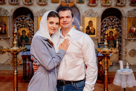 beautiful married couple in the church. Christian family religious traditions.の写真素材