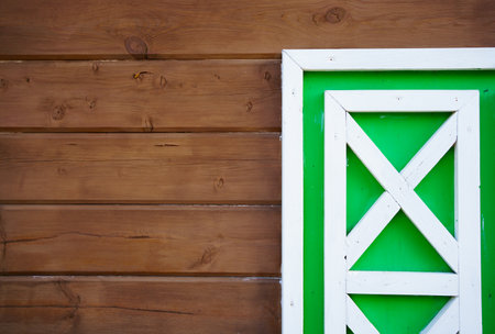 fragment of a white-green shutter on the wooden boards.の写真素材
