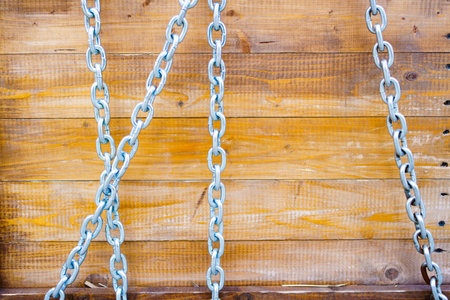 wooden boards with metal chain. background with the texture of a tree.の写真素材