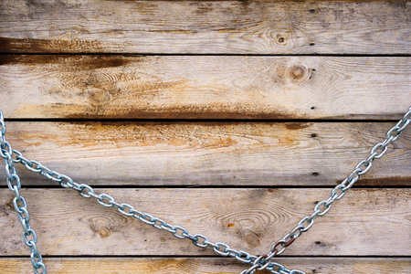 wooden boards with metal chain. background with the texture of a tree.
