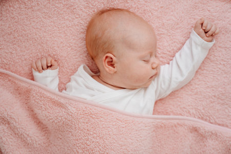 sleeping baby under the pink blanket. healthy sleep in newborns.の写真素材