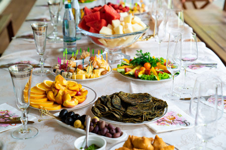 table served with light summer snacks-fruits, vegetables, berries.の写真素材
