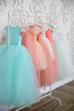 Hanger with colorful elegant puffy dresses for girls. holiday wardrobe.の写真素材