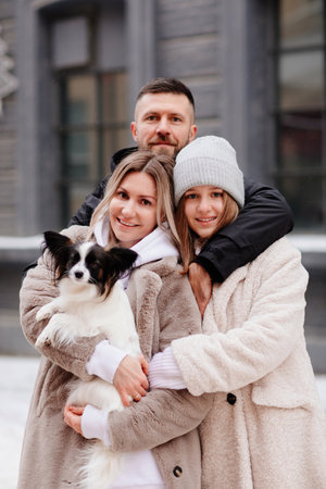 beautiful family with dog Papillon on street. photo shoot.の写真素材