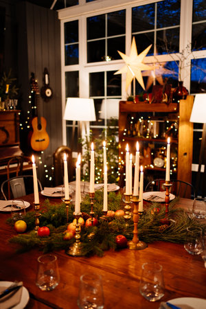 large square wooden table served for Christmas dinner. retro styled. Low light.の写真素材