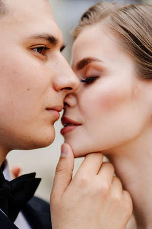 beautiful, gentle and happy bride and groom. man gently touches womans faceの写真素材