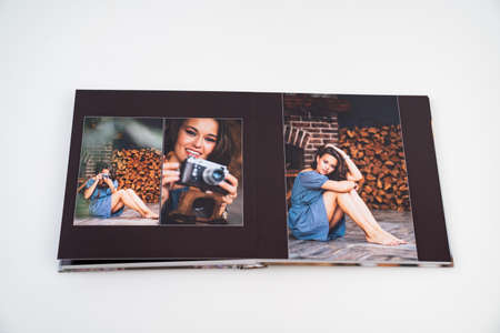 pages of photobook from photo shoots of beautiful brunette woman in retro house.の写真素材