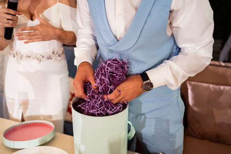 The bride gives a speech into the microphone and gives a surprise giftの写真素材