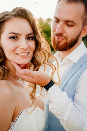 solar glare. bride with long curls in a white elegant dress withの写真素材