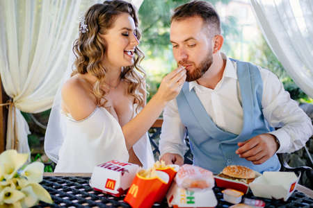 The bride and groom eat food from McDonalds. snack for the newlywedsのeditorial素材
