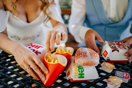 The bride and groom eat food from McDonalds. snack for the newlywedsのeditorial素材