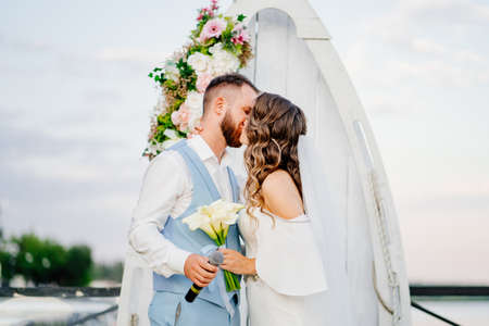 wedding vows. beautiful ceremony by the water on the dock.の写真素材