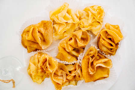 stuffed pancakes on a white plate. a treat for the holiday table. Maslenitsa.の写真素材