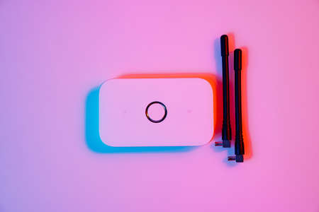mobile modem in multicolored lighting. device has SIM card supported by 4G
