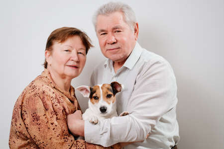 An elderly couple with a dog on a white background.の写真素材