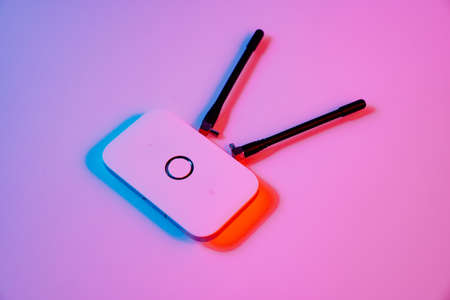 mobile modem in multicolored lighting. device has SIM card supported by 4G