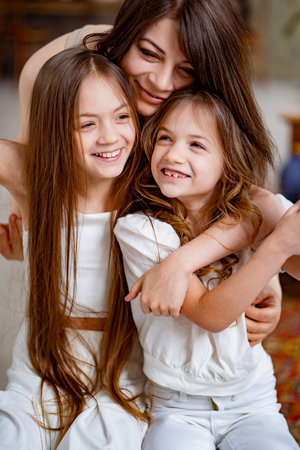 mom hugs daughters rides on a swing in the loft. mothers dayの写真素材