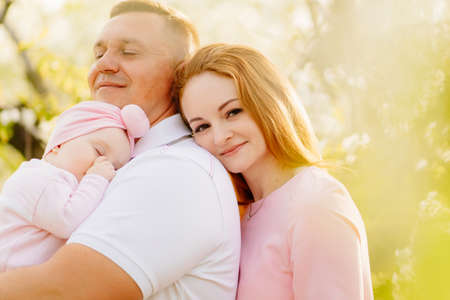 family with a baby daughter. the baby wants to sleep and sucks her fingerの写真素材