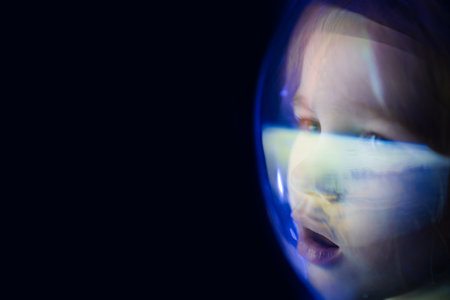 girl dreams of becoming astronaut and flying into space. reflection of planetの写真素材
