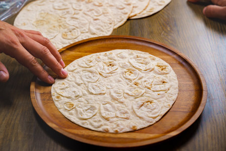 flatbread pita on a round wooden cutting board. bakery. flat breadの写真素材