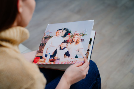 woman watches photobook from a family photo shootの写真素材