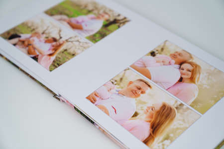 white background open photobook from family photo shoot in spring gardenの写真素材