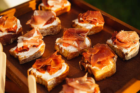 canapes with sauce and meat for the buffet. catering for a dinner party.