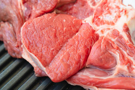 piece of beef on bone on black grill pan .natural and eco-friendly farm products