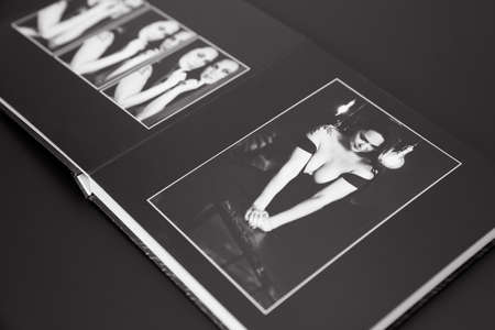 open photobook from a photo shoot of an attractive woman on a black background.の写真素材