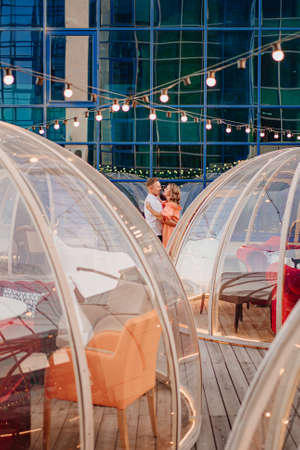 happy, beautiful man and woman in love in original place for dating on rooftop