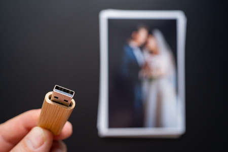 stack of wedding photos and flash drive. selective focus.の写真素材