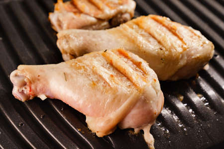 pieces of chicken are fried in an electric grill.の写真素材