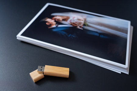 stack of wedding photos and flash drive. the result of the photographers workの写真素材