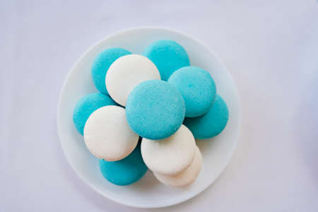white and pigeon macaroons on a plate. traditional French almond flour cakesの写真素材