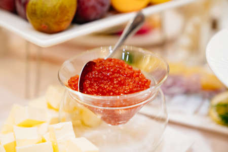a bowl of red caviar and butter on the dining table. delicacies for the holidayの写真素材