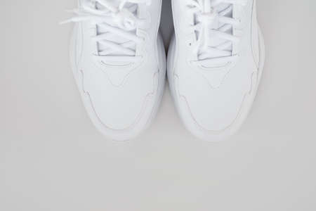 white sneakers with laces on a white background. isolate. top view.の写真素材