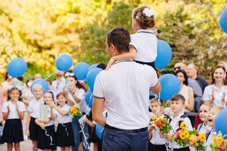 a high school student carries a first-grader with a bell on his shoulder.のeditorial素材