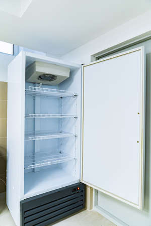 empty refrigerator shelves in the dining room.の写真素材