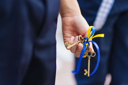 mortgage for families with children. a kid holds the keys to the school.の写真素材